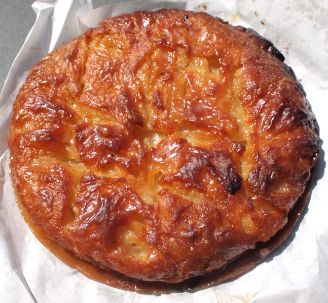 a baked item on a table in a paper wrapper