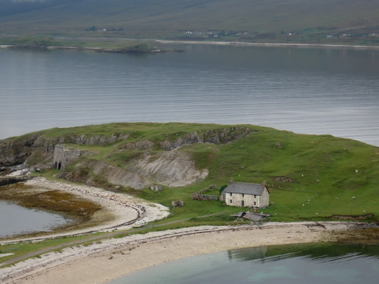 a house that is on top of an island by the water