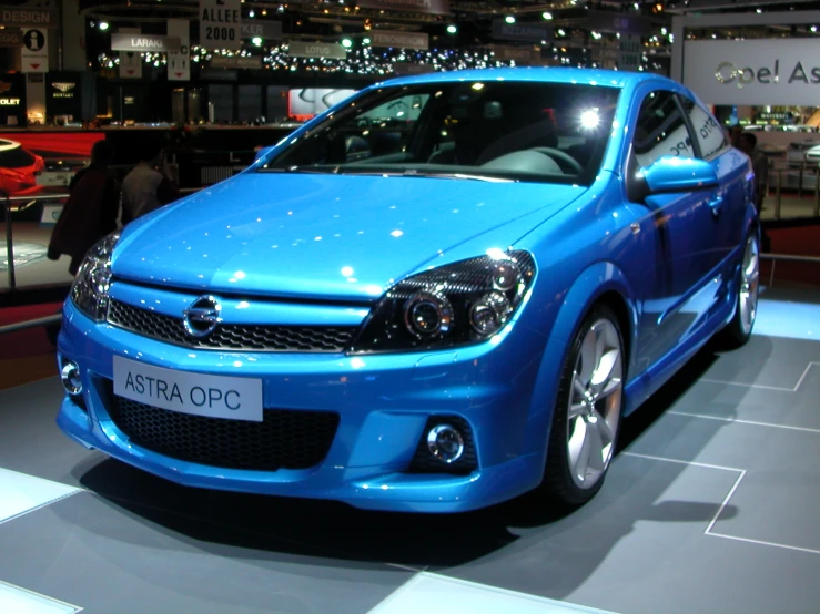 a blue car parked next to a white and black floor