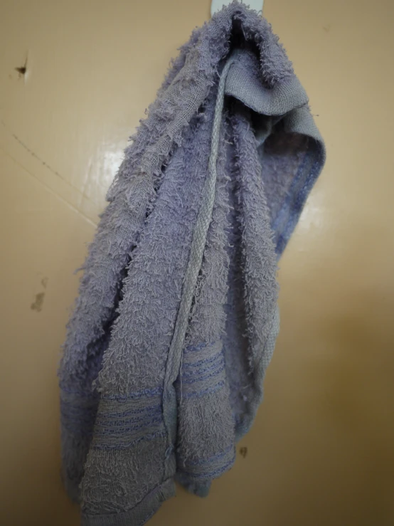 a blue towel hanging from a hook