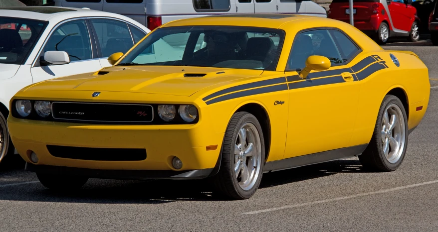 a dodge demon car is parked next to a white sports car