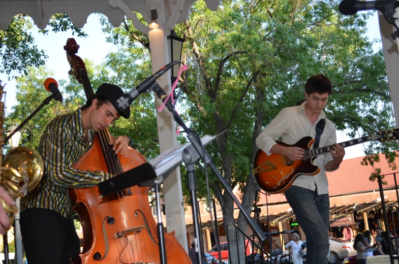 two people playing music and standing on steps