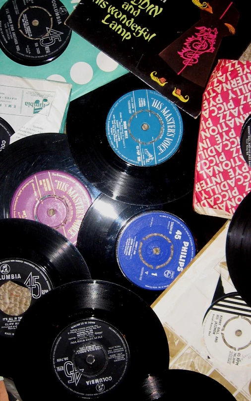 an assortment of various records including various colored record disks