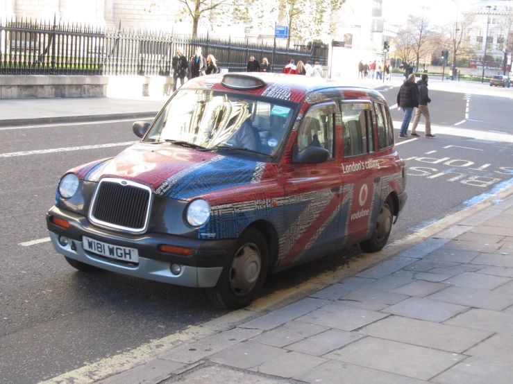 a large red car with a blue and white design painted on it's front