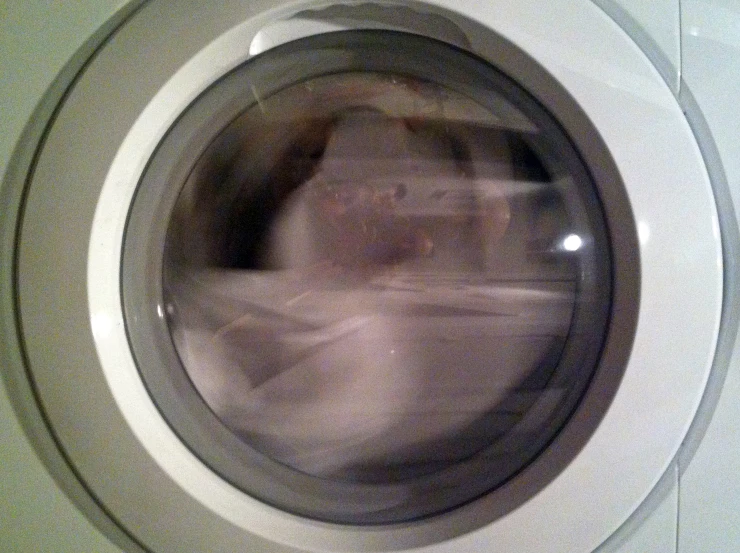 a person in a front loading washing machine