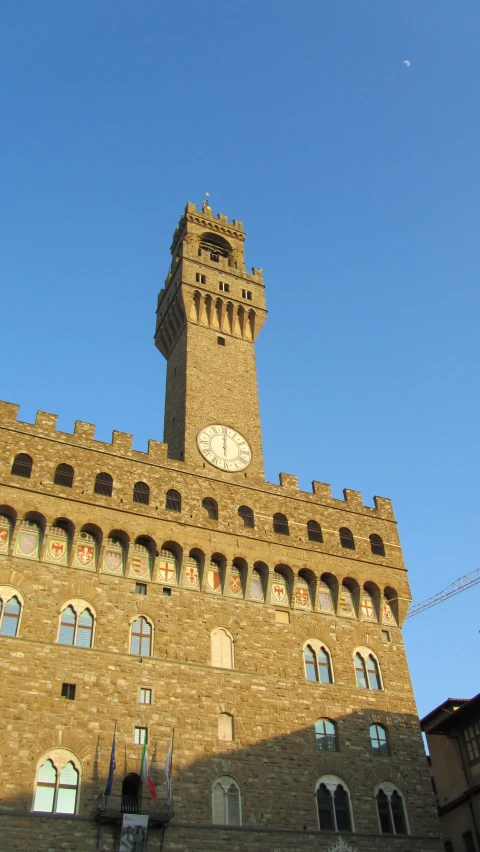 the clock tower stands above a stone building