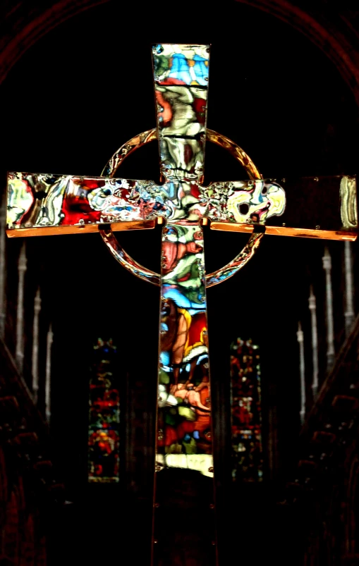 a church cross lit up with colored lighting