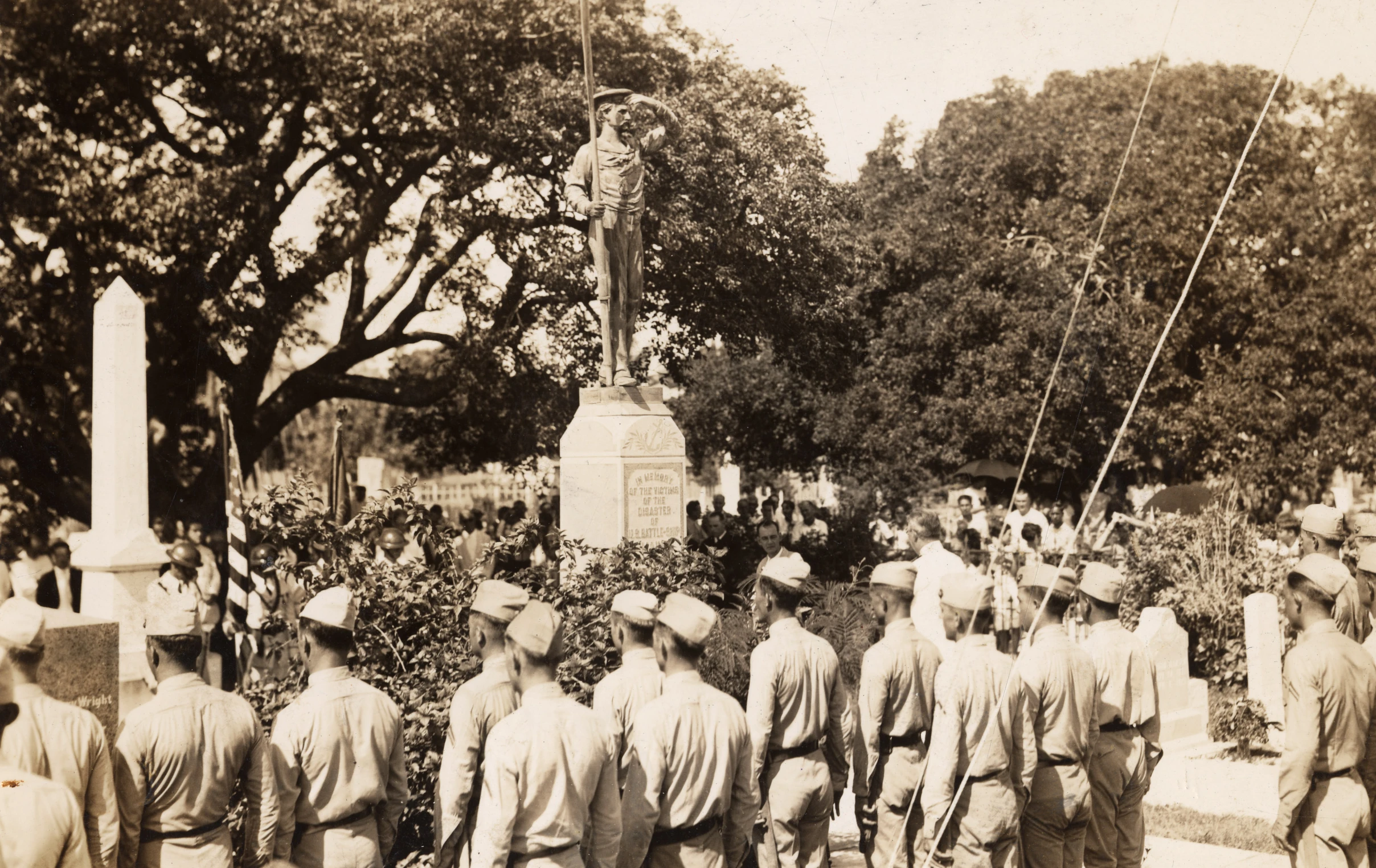 soldiers stand in front of a memorial