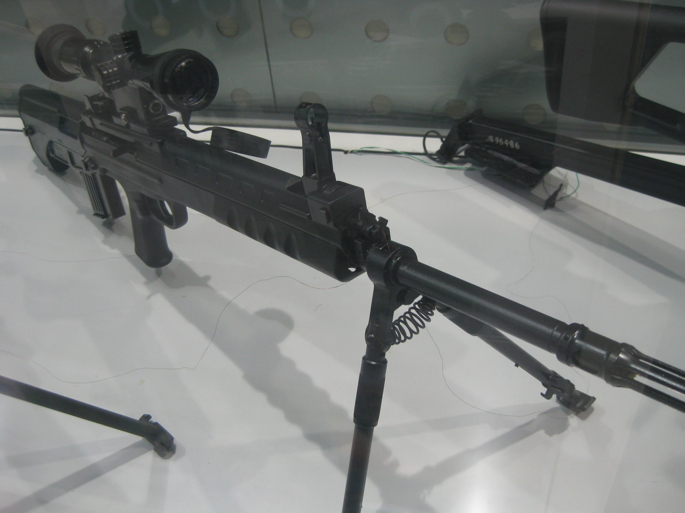 a black gun with long guns connected to it