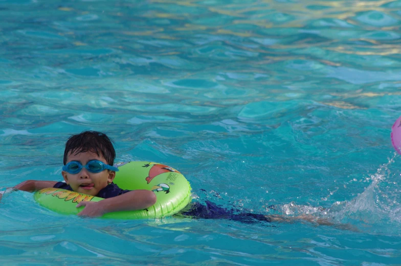 a  swimming in the pool wearing goggles