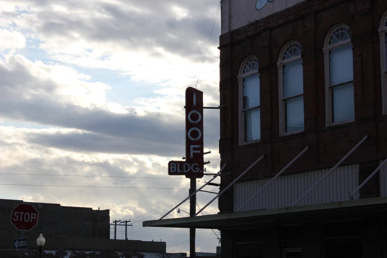 this is an old building with a red stop sign