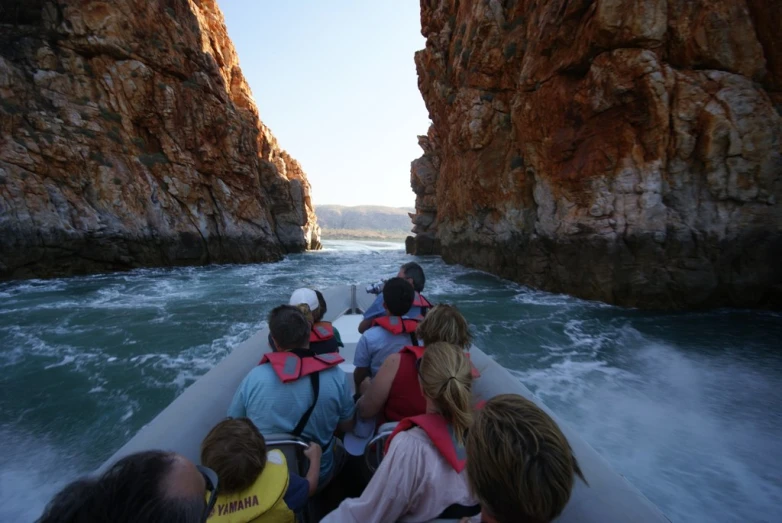 a group of people on a boat ride in the middle of a river