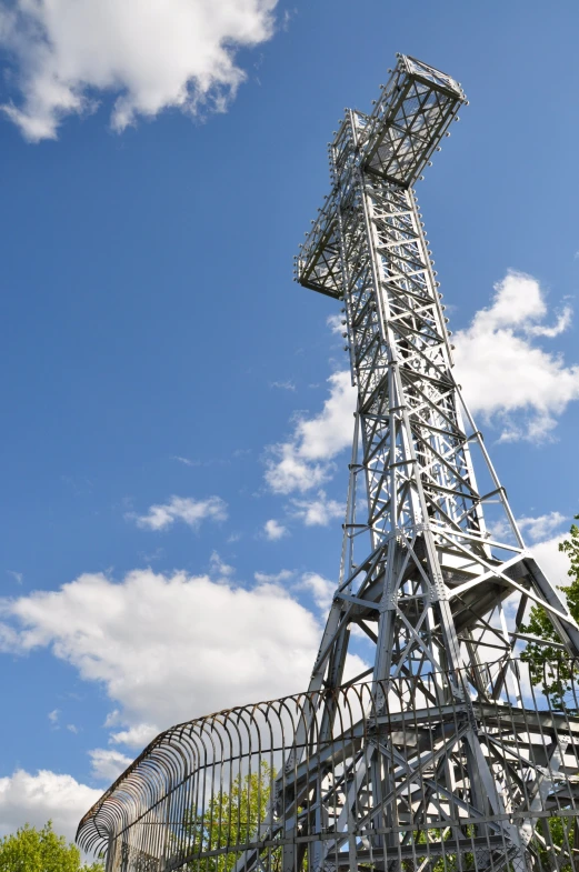 a very tall metal structure with a clock on top