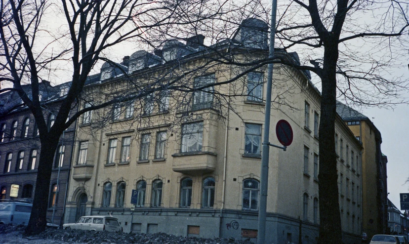 a po of a very old yellow building with some big windows