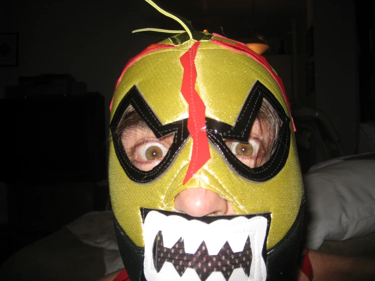 a boy wearing an ugly looking mask to his face