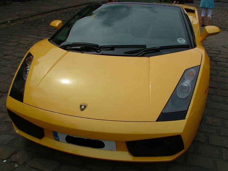 a close up view of the front of a yellow car