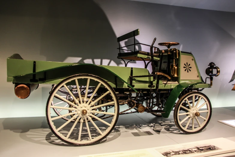 an old green vehicle on display at a museum