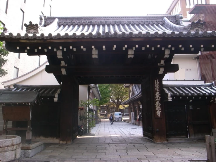 an image of an asian archway in the middle of the city