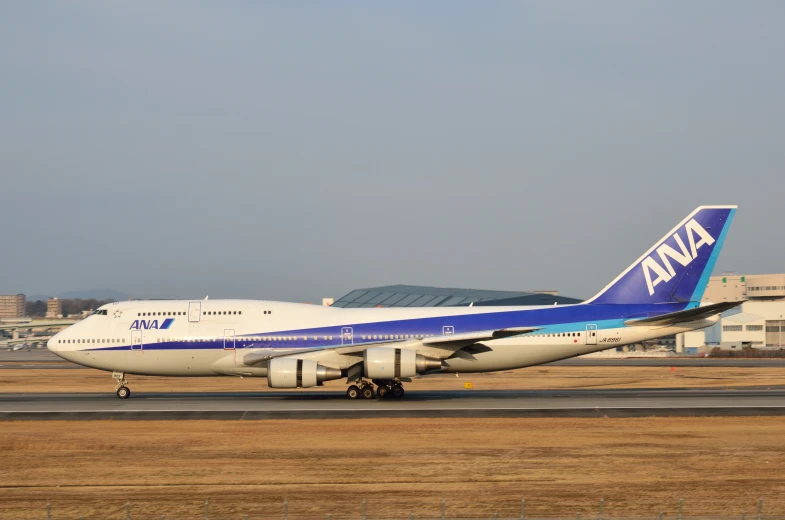 an ana 747 parked on the tarmac at an airport