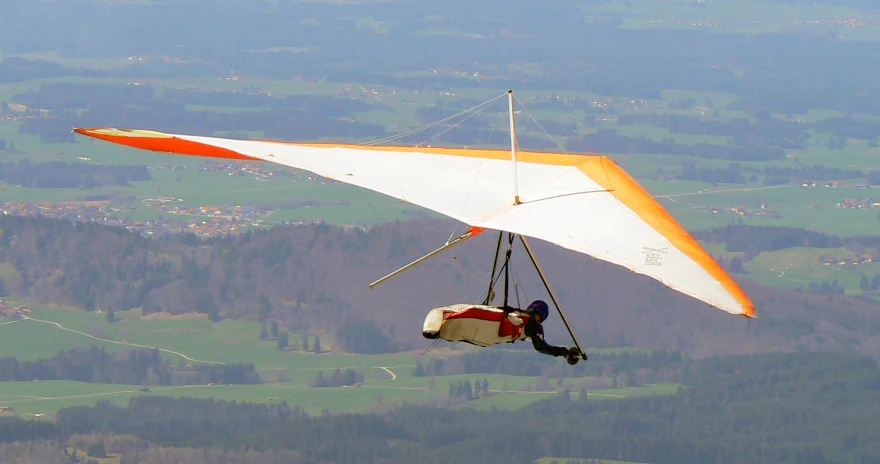 a person riding a wind glider over a mountain