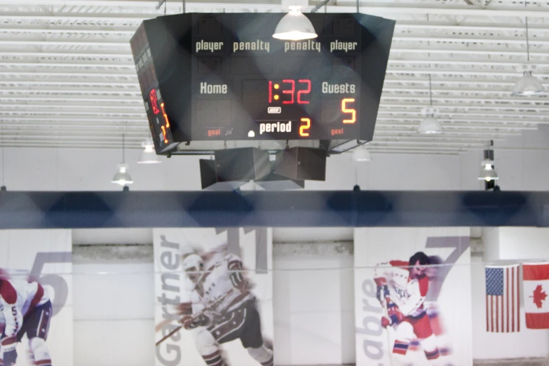 large digital score board hanging on the ceiling in a room