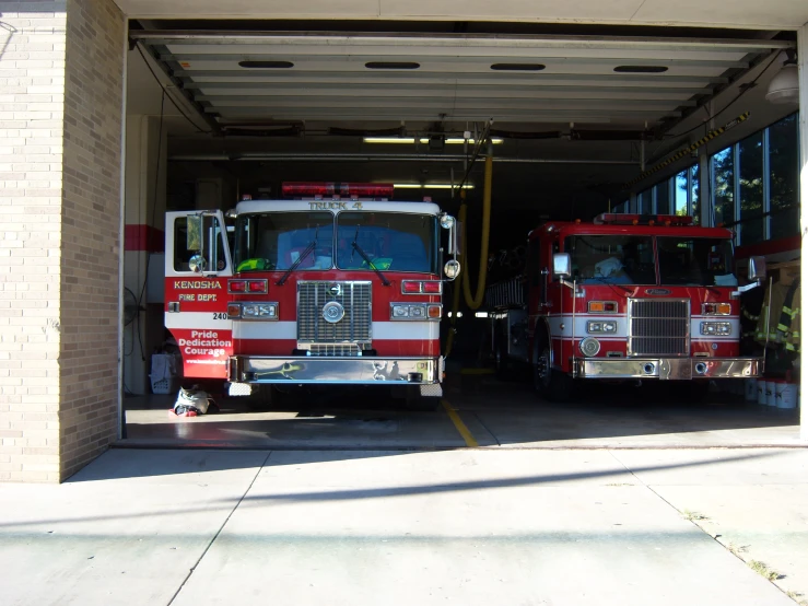 two fire trucks are parked in the garage