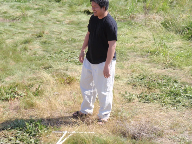 a man standing in a field, on a sunny day