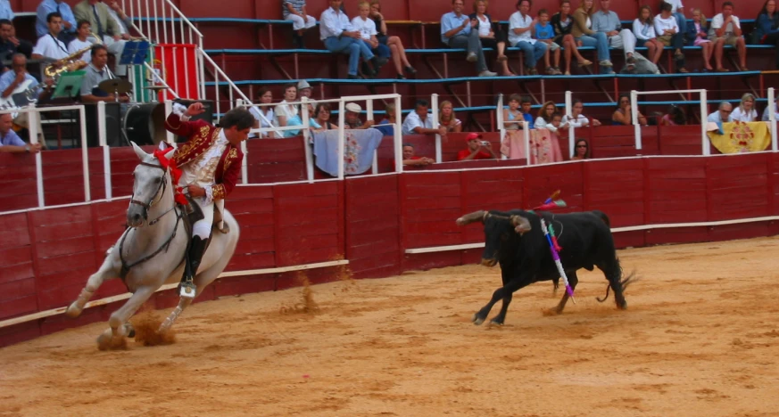 an image of a horse and rider chasing a cow