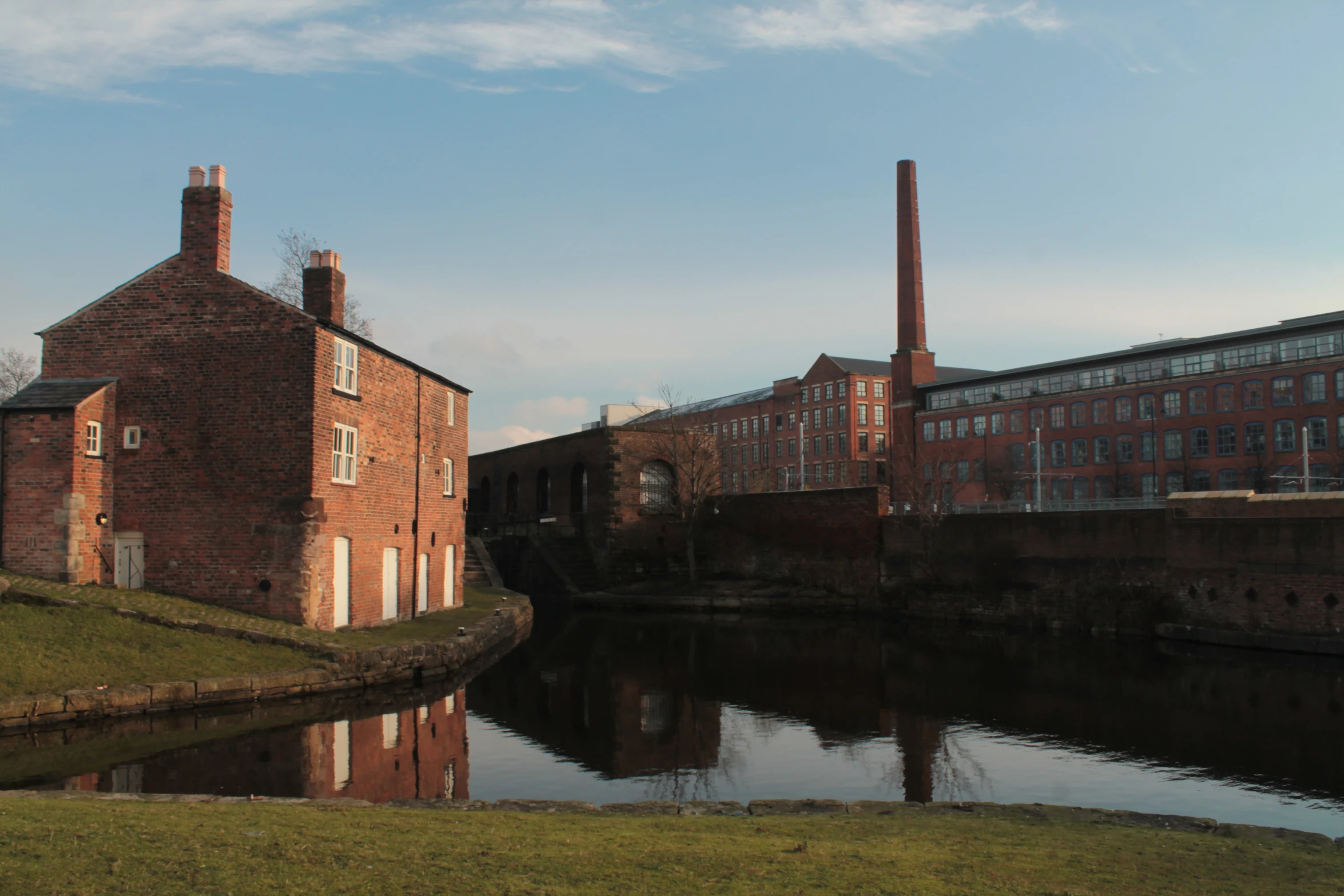 a water front area with a building and river running past it