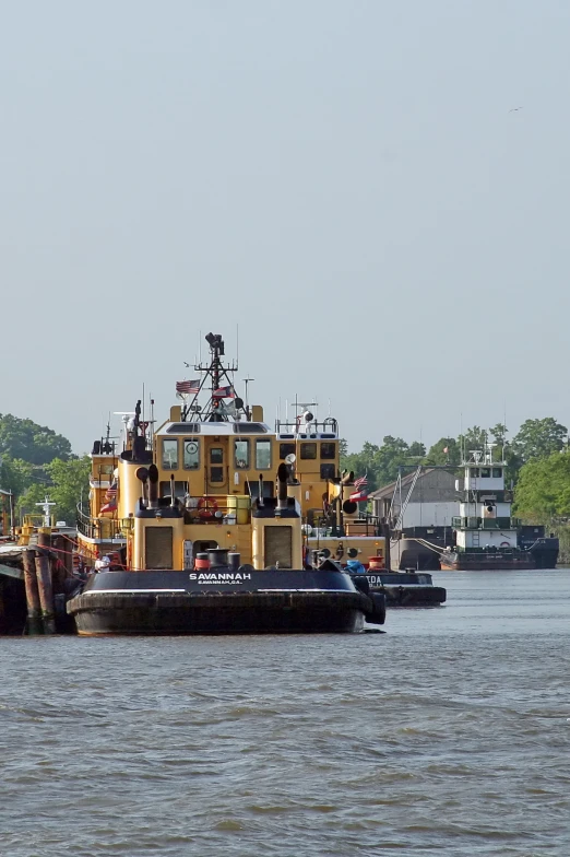 the large tugboat is carrying a barge