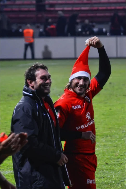 two soccer players are standing on the field together