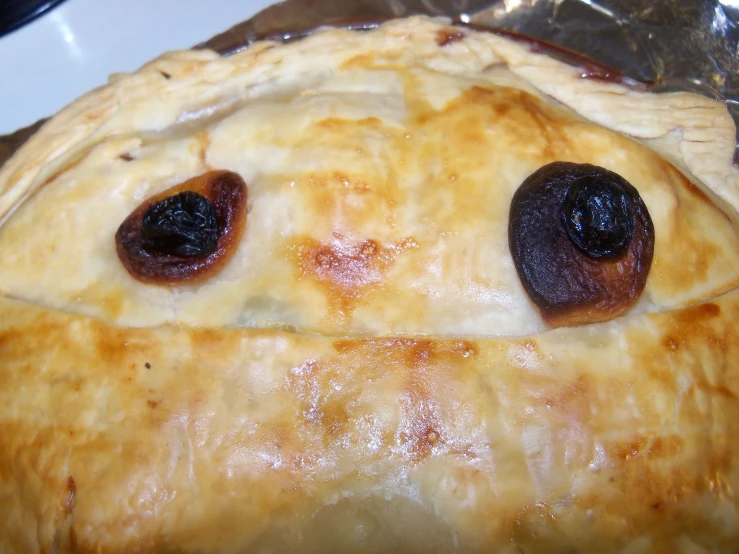 close up of an ovening pie with olives