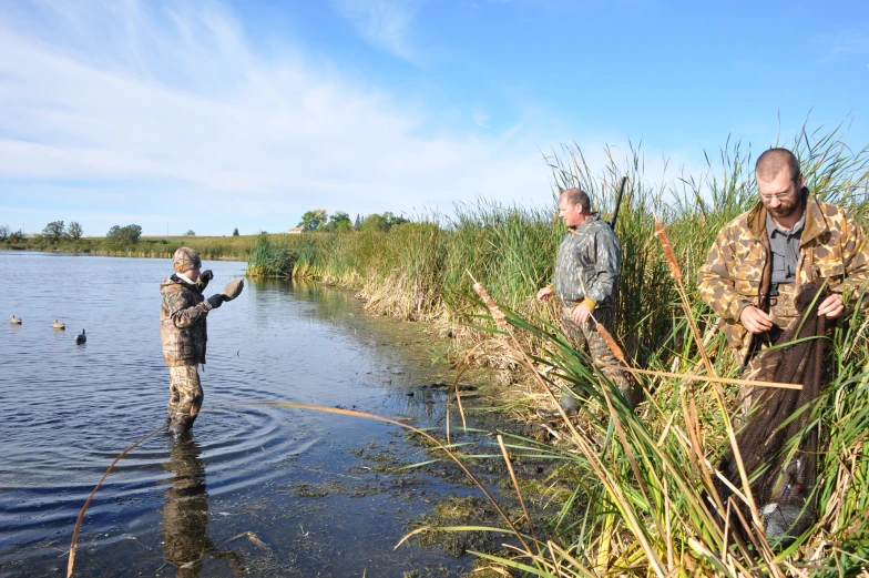 a person standing in a river with a fish