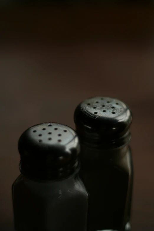 two salt and pepper shakers sit on a table