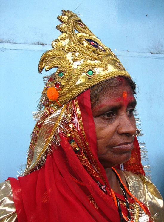 a woman is dressed in gold and red