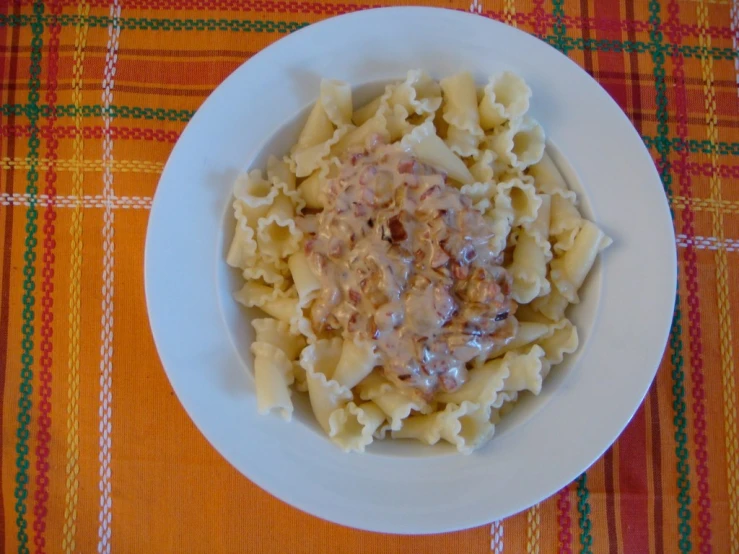 a white bowl filled with cooked pasta and sauce