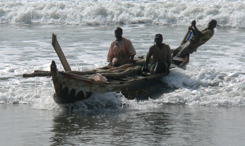 some men in a boat near an ocean