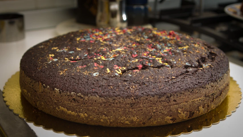 a cake with sprinkles sits on a plate