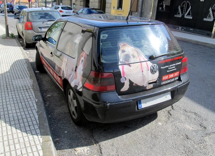 car parked on side of street with picture of a dog on the window