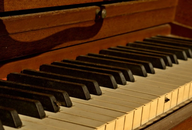 an old piano with wooden case and keys