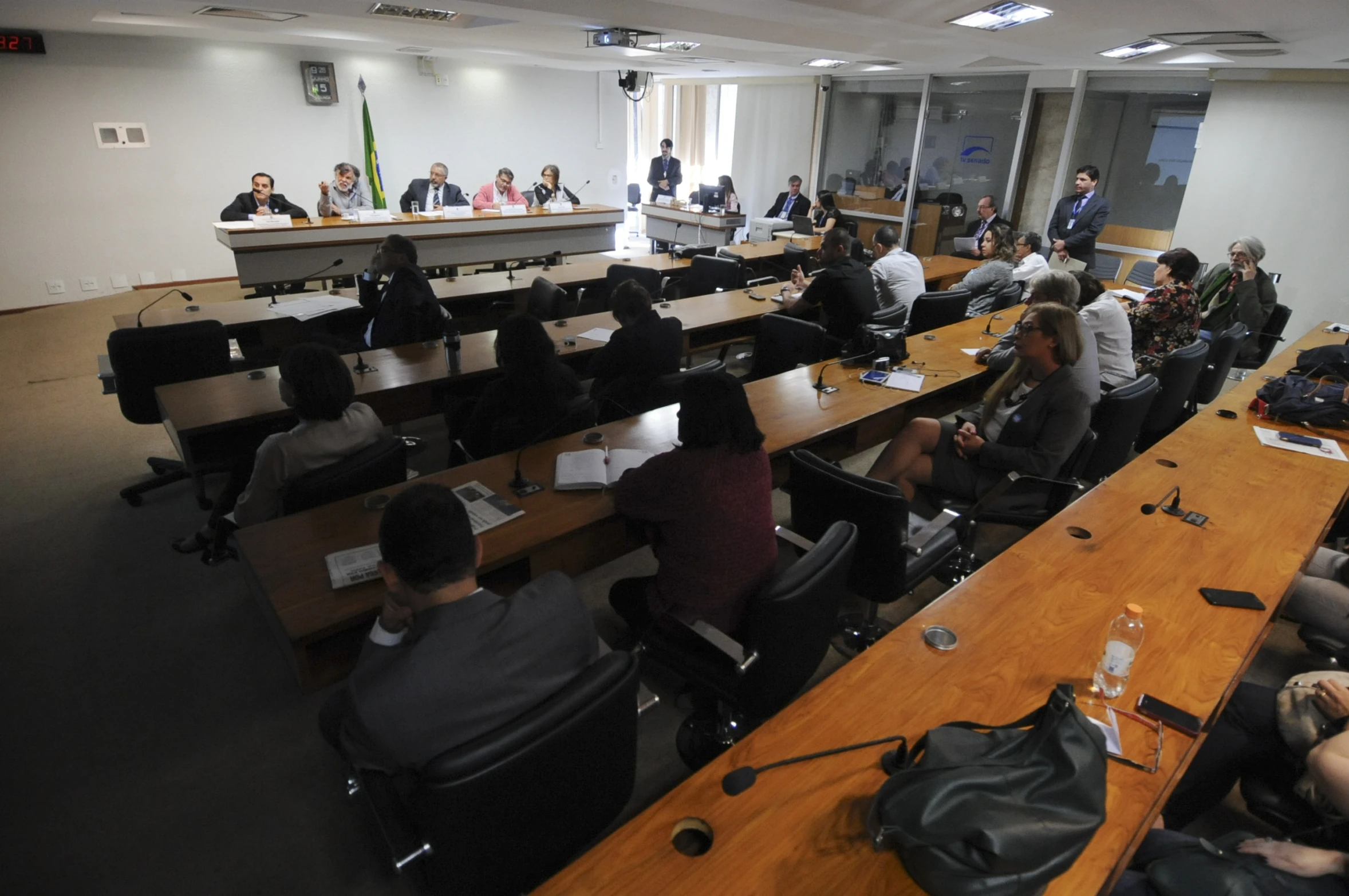 group of people sitting in large chairs around conference table