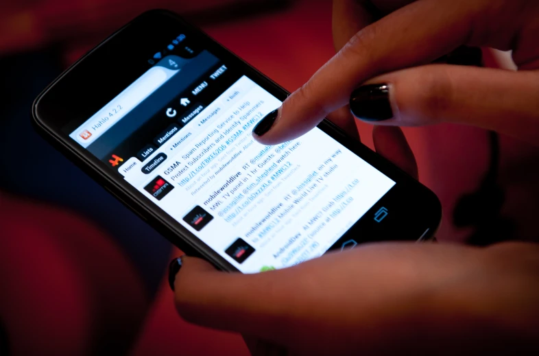 person touching on a mobile device showing other news pages