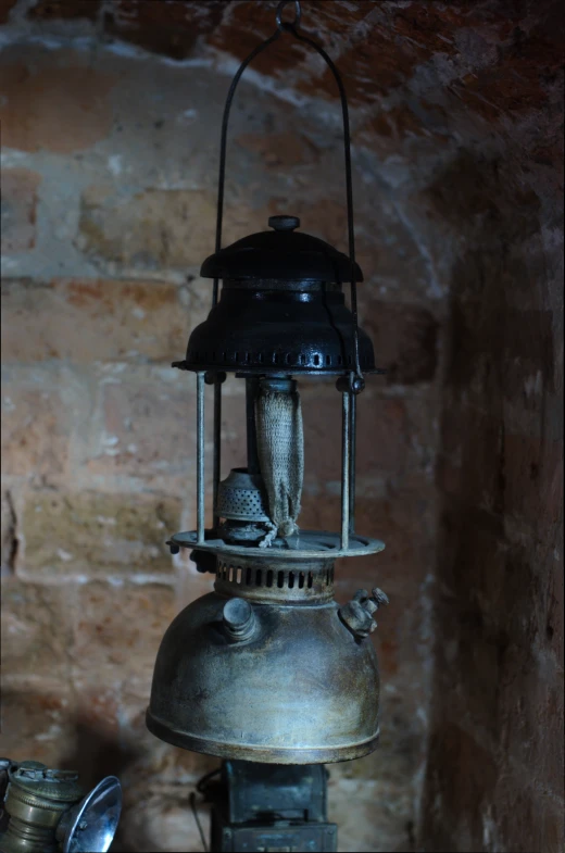 an old fashioned metal lamp with two bellows on it