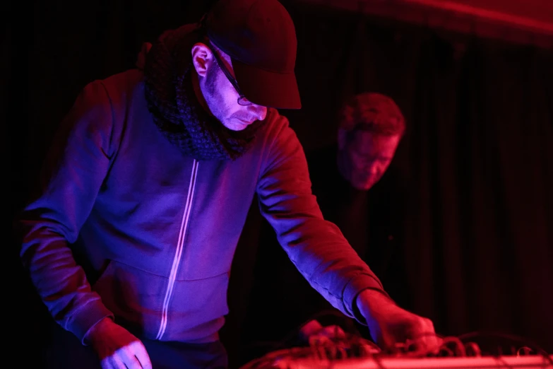 a dj spinning music equipment with his hands