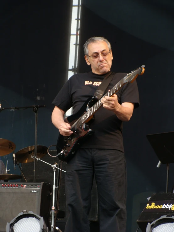 a man that is playing a guitar on stage