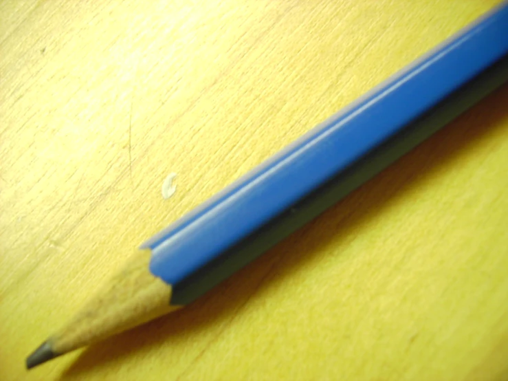 a pencil is lying on top of the wood