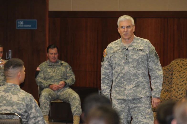 a group of men in camouflage uniforms stand together