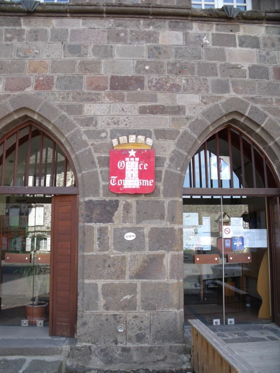 an old brick building has a red sign on the front