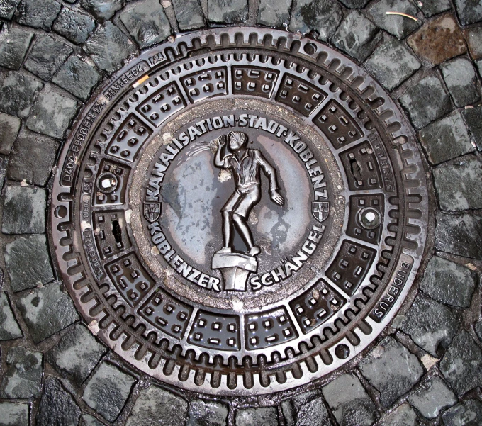 this circular iron grate shows the image of a man running