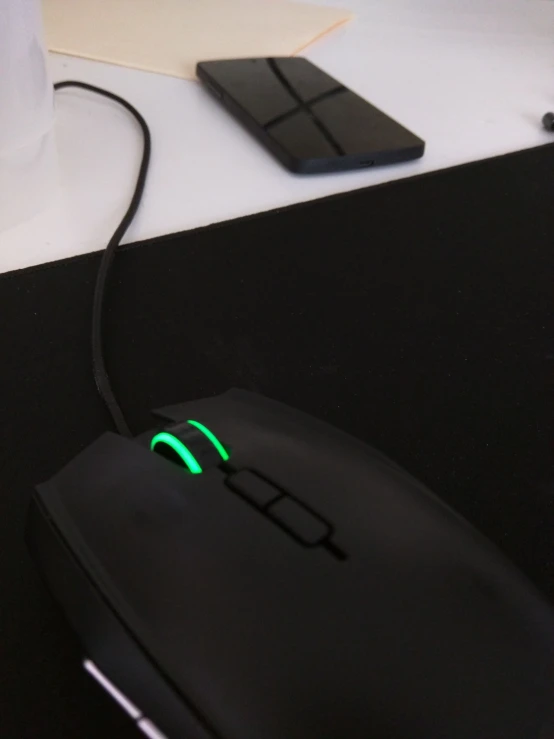 a close - up of a black mouse with a glowing green on